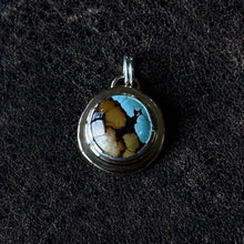 Load image into Gallery viewer, a round gold pendant with a turquoise stone. Mixed metal silver and gold
